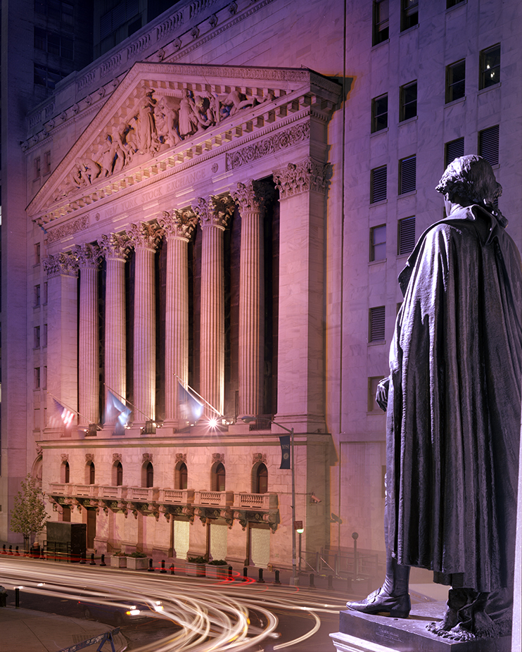 The New York Stock Exchange and statue of General George Washington at night 